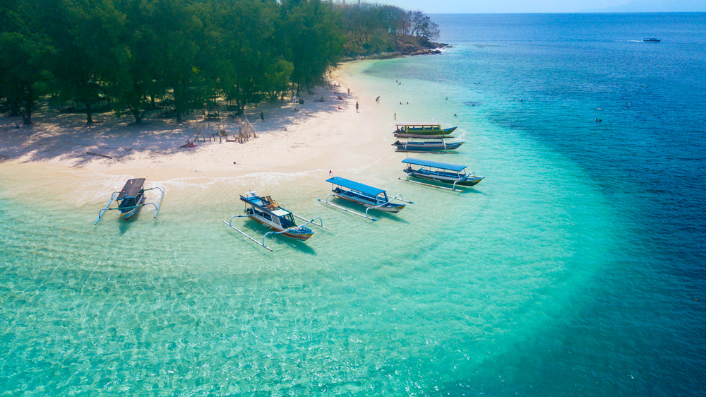 Tourist ships anchored on the Gili Rengit beach