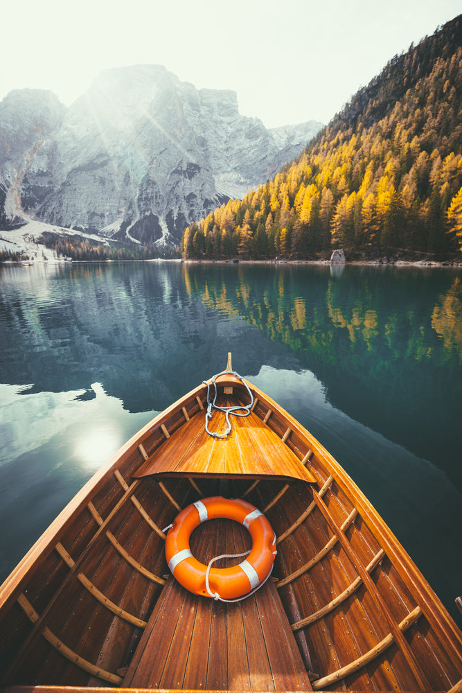 Traditional rowing boat on a lake in the Alps in fall